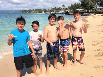 5 boys on beach at Aloha Beach Camp summer sleepaway camp in Hawaii
