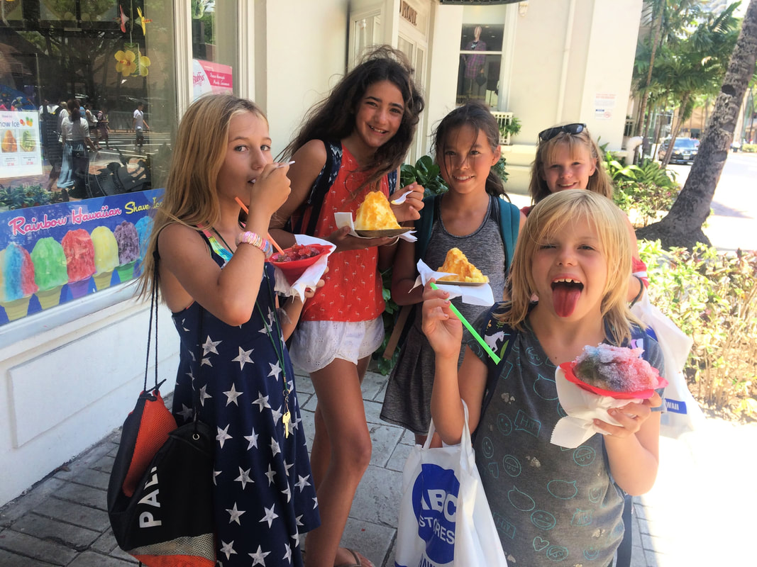 5 girls enjoying a refreshing shave ice treat at summer camp in Waikiki Beach