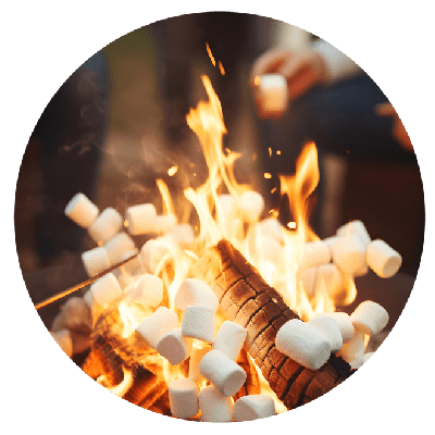 Friends roasting marshmallows around the campfire at Aloha Beach Camp Hawaii's summer sleepaway camp on Oahu