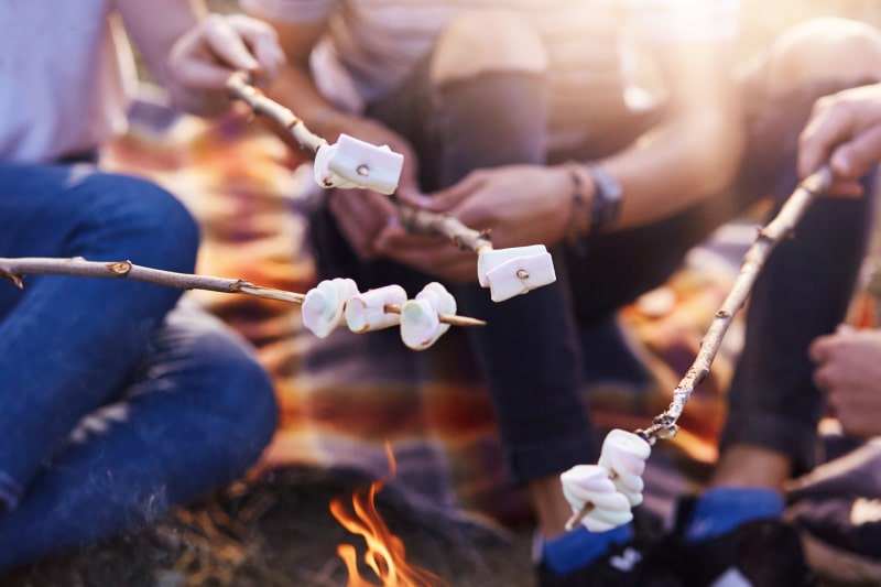 Roasting marshmallows at Aloha Beach Camp Hawaii's campfire