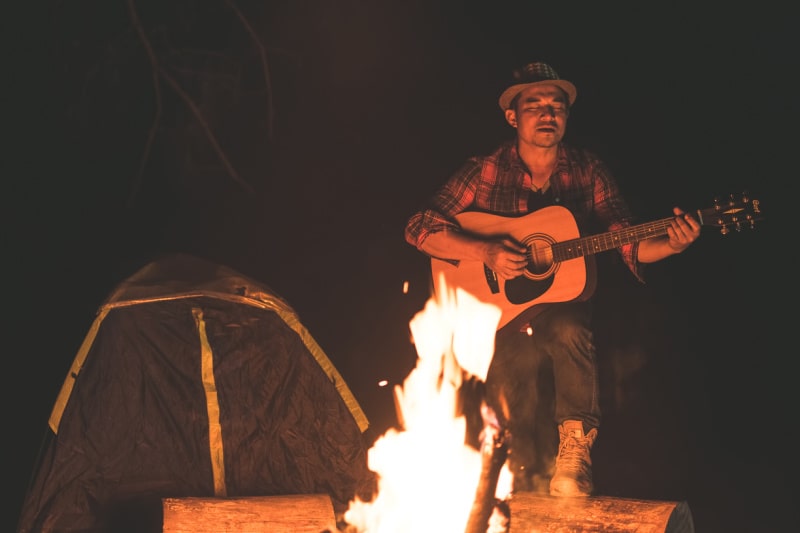 Counselor singing campfire songs at Aloha Beach Camp Hawaii