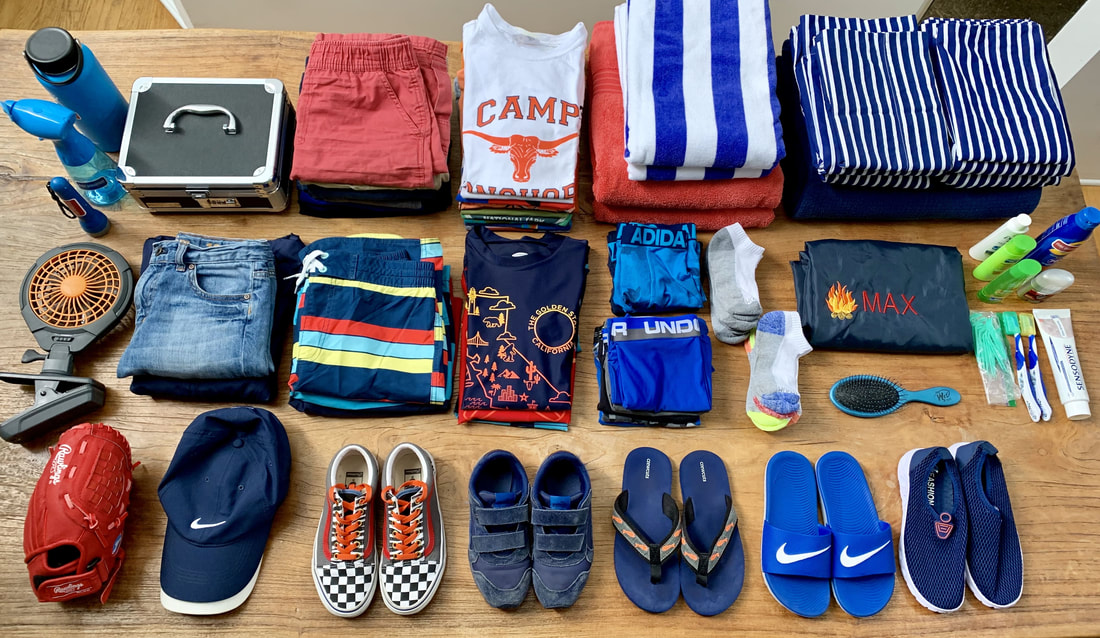 Clothing and supplies laid out on a table for a camper to bring to summer camp in Hawaii